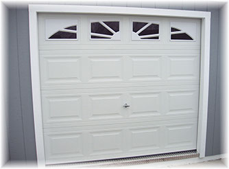 Overhead garage door on portable storage shed
